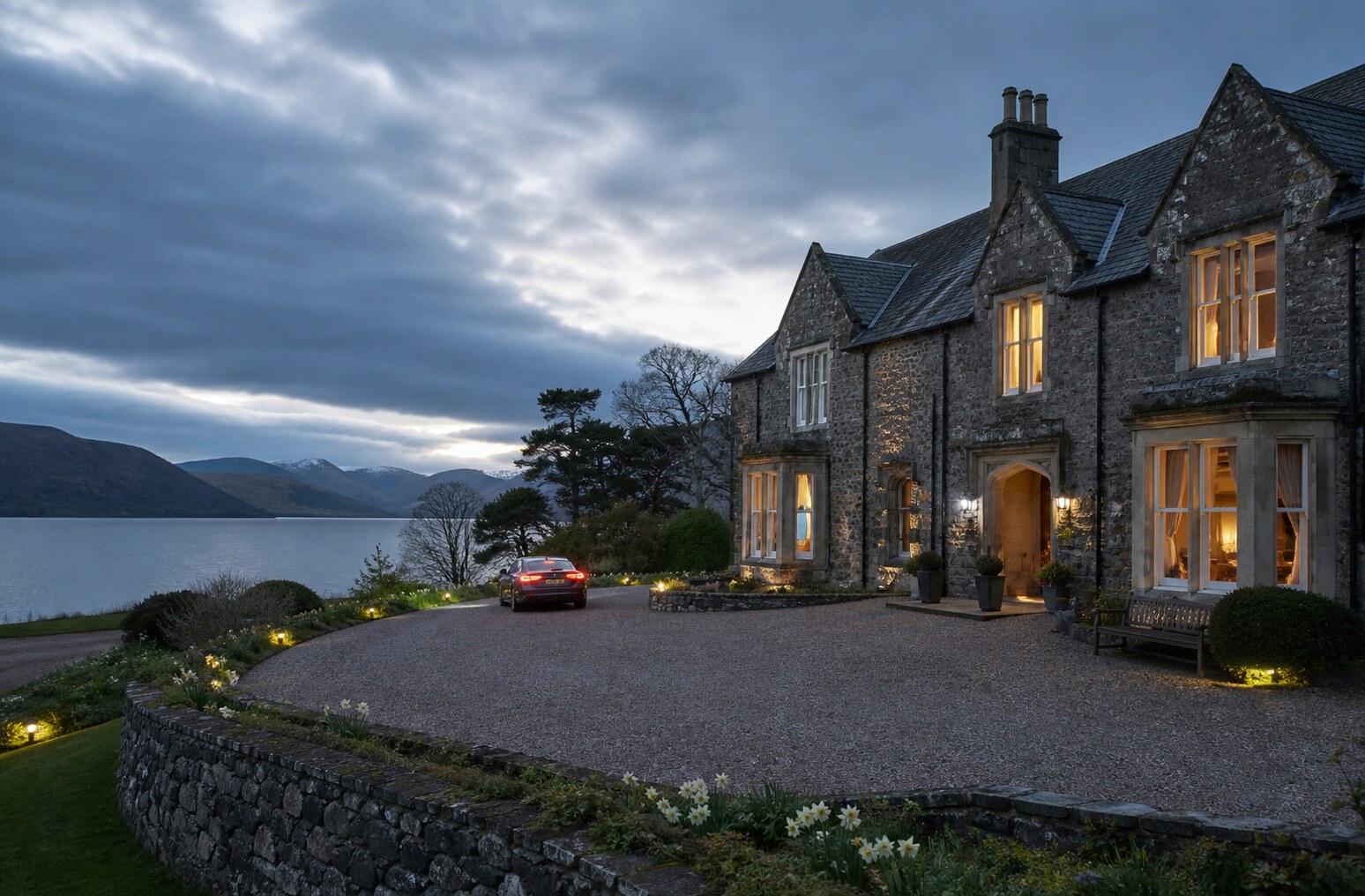 Lake Manor beside a calm Lake District lake at dusk